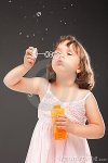 little-girl-blowing-soap-bubbles-20769077.jpg