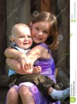 cute-little-girl-holds-baby-boy-smiles-24236351.jpg