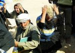 iraqi-shiites-throw-dust-on-their-heads-in-grief.jpg
