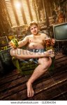 stock-photo-fat-man-eating-hamburger-seated-on-armchair-112364354.jpg