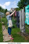 caucasian-woman-hanging-washing-in-garden-taken-in-bristol-england-de8gbc.jpg