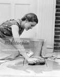 846-02793257em-1930s-1940s-WOMAN-HOUSEWIFE-KNEELING-SCRUBBING-DOORWAY-FLOOR-WITH-BUCK.jpg