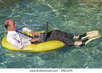 stock-photo-businessman-in-an-inflatable-boat-wearing-his-business-suit-and-tie-and-also-yellow-.jpg