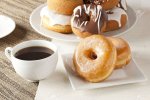 15918485-fresh-homemade-donuts-and-coffee-against-a-background.jpg