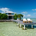 Beautiful-Fresh-Turquoise-Beach-House-Interior-Design-With-Wooden-Chair-on-Dock.jpg