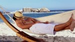 stock-footage-man-wearing-straw-hat-relaxing-in-a-hammock-on-the-beach.jpg