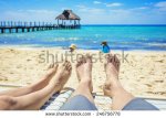 stock-photo-tan-feet-of-a-couple-on-lounge-chairs-enjoying-a-beach-vacation-while-watching-their.jpg