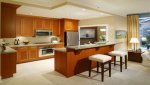 interior-kitchen-white-kitchen-design-with-l-shaped-brown-stained-wooden-cabinet-combined-with-i.jpg